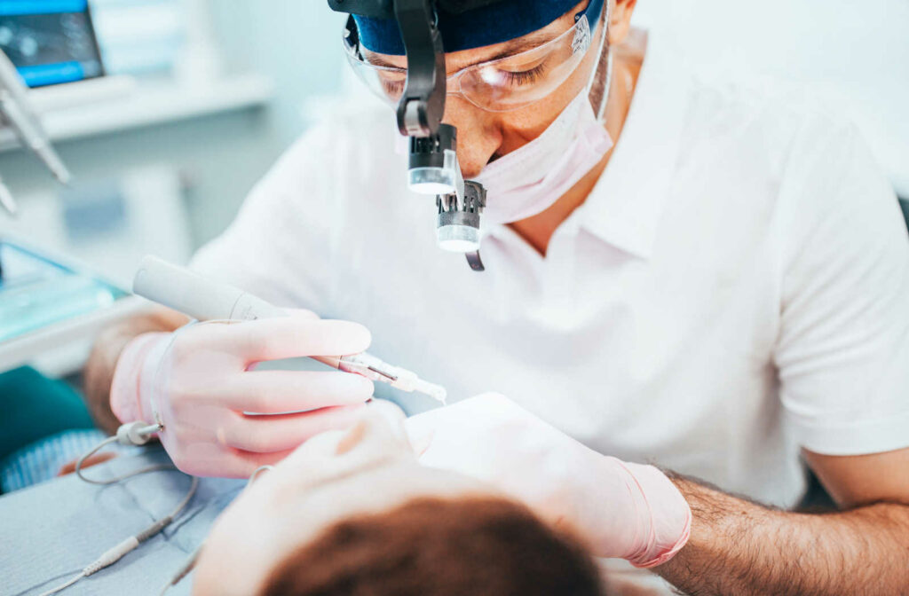 A dentist performing a root canal on a patient with an infected tooth.