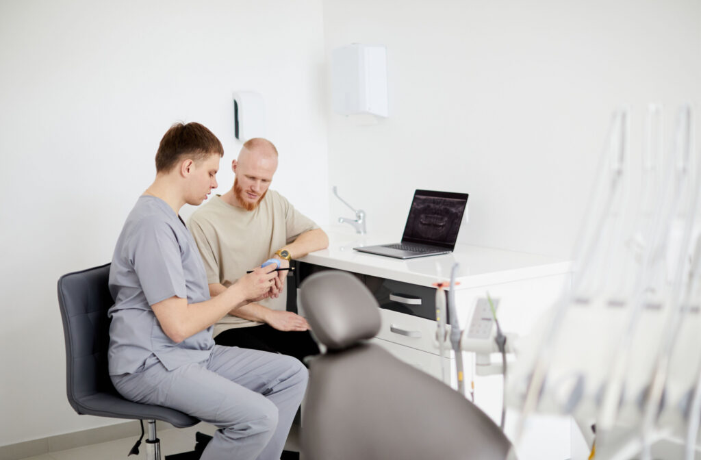 A dentist explaining to his  attentive patient what to expect from laser dentistry.