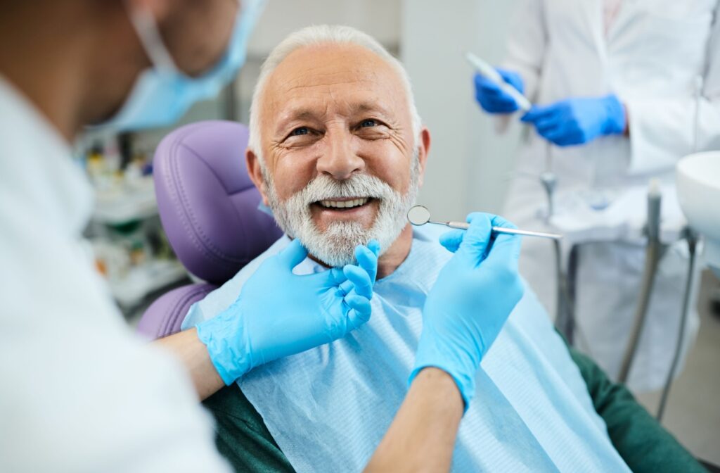 A senior male having a dental check up with the help of the Canadian Dental Care Plan.