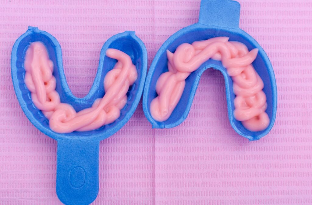 Two trays with fluoride gel treatment in them ready to apply to a patient's teeth.