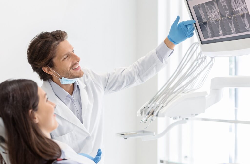 A dentist showing a patient their dental X-rays