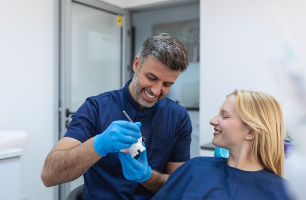 A dentist explaining to a patient what to expect during a crown lengthening procedure.